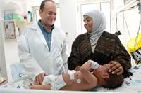 Dr Houri with a Palestinian mother and child, by Sheila Shalhevet